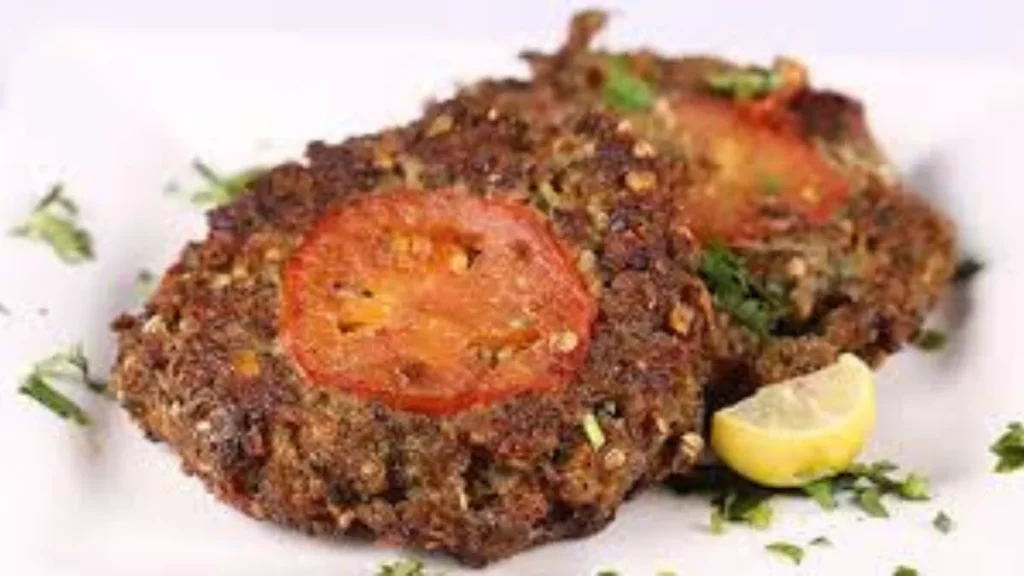 How to make Chapli Kabab soft and juicy – traditional Pakistani-style kebab garnished with tomato slices and lemon.